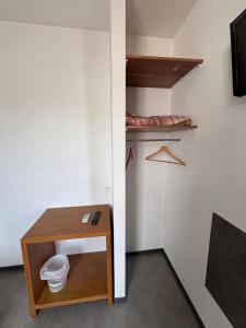 a room with a small table and a bed at Hôtel 2 Étoiles centre ville in Mont-de-Marsan