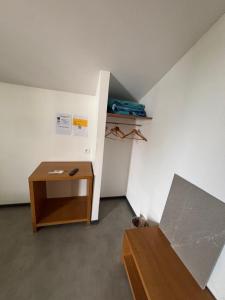 a room with a desk and a bed and a table at Hôtel 2 Étoiles centre ville in Mont-de-Marsan +5 photos