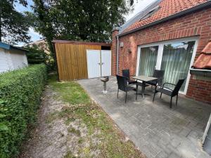 a patio with a table and chairs next to a building at Loft Hesel, 35232 in Hesel