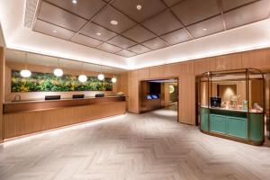 a lobby of a hotel with wooden walls and wooden floors at Orange Hotel Hangzhou Joy City in Hangzhou