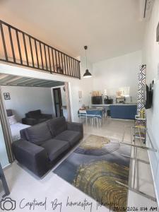 a living room with a couch and a bed at Homestay Studio TOKAYOH in Kota Bharu