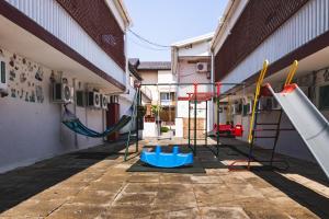 an empty playground with a slide and swings at Casa Galbena Paflora Saturn in Saturn