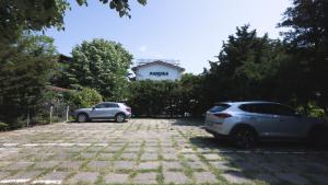two cars are parked in a parking lot at Casa Galbena Paflora Saturn in Saturn