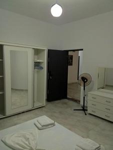 a room with a bed and a closet and a mirror at Rooms New DiamonD in Durrës +41 photos