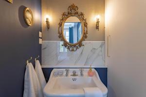 a bathroom with a sink and a mirror at L'Ecrin des Corbières in Treilles +68 photos