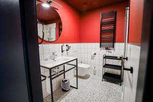 a bathroom with a sink and a toilet and a mirror at Arche Hotel Piła in Piła +75 photos