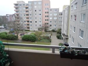 a balcony with a view of a park and buildings at Private Apartment Laatzen City in Hannover
