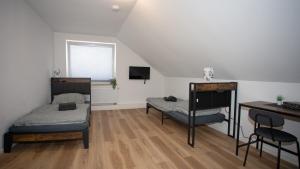 a bedroom with two beds and a desk and a piano at Cesar Apartments in Wathlingen