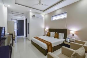 a hotel room with a bed and a television at Royal Residency 610 Golf View in Gurgaon