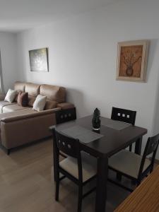 a living room with a table and a couch at EDIFICIO SANTA GEMA 2k in La Cala de Mijas