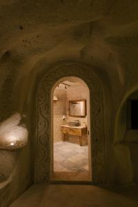 an archway in a room with a sink in it at Cappadocia Cave Suites in Göreme