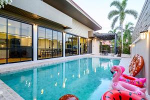 a swimming pool with a pink flamingos in the water at Modern Spacious 3-bed Ban Amphur Pool Villa (BA1) in Na Jomtien