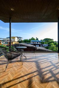 a patio with a table and a bench on a roof at Modern Spacious 3-bed Ban Amphur Pool Villa (BA1) in Na Jomtien