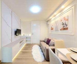 a living room with a couch and a table at Joyful Room Poppular Condo P1 in Ban Song Hong