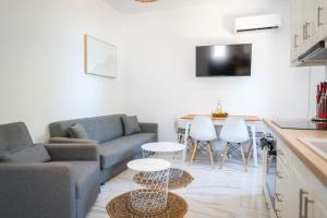 a living room with a couch and a table at The Rock Seaside House - Etheras Properties in Kythira