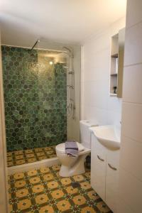 a bathroom with a toilet and a sink and a shower at The Rock Seaside House - Etheras Properties in Kythira +24 photos
