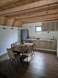 a kitchen and dining room with a table and chairs at River Zen House in Šipovo