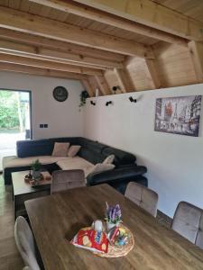 a living room with a couch and a table at River Zen House in Šipovo +11 photos