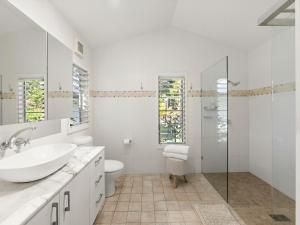 a white bathroom with a sink and a toilet at Fairview in Rosebank +10 photos