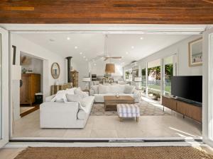 a living room with white furniture and a large window at Fairview in Rosebank