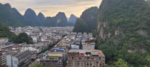 a view of a city with mountains in the background at YangShuo Backpacker Hostel West Street Branch in Yangshuo