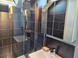 a bathroom with a sink and a mirror at Chambre de Camille à Gerpinnes in Gerpinnes +9 photos