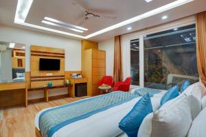 a hotel room with a bed and a television at Hotel Skynex - Near Delhi Aerocity in New Delhi