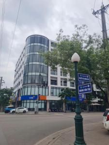a building with a street sign in front of it at Zen Central Hotel Bac Giang in Bắc Giang