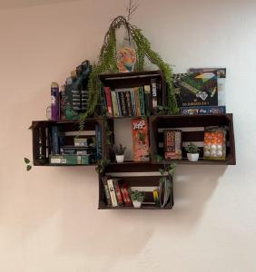 a book shelf on a wall with books at Sol de México in Isla Mujeres