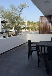 a table and a chair sitting on a patio at Sol de México in Isla Mujeres