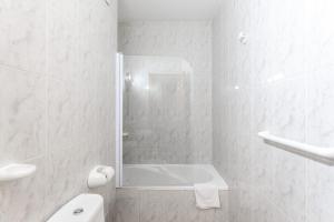 a white bathroom with a shower and a toilet at BF Rooms Garrucha in Garrucha +73 photos