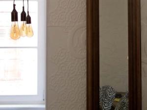 two lights hanging from a wall next to a window at L'Escale de Broglie in Broglie