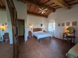 a bedroom with a bed and a wooden ceiling at Agriturismo Casa Greppo in San Venanzo +195 photos
