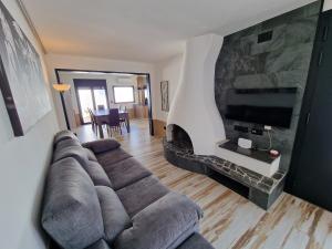 a living room with a couch and a fireplace at VILLA CALA LLARGA BEACH in Roses