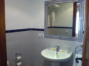 a bathroom with a sink and a mirror at Hostal El Espinel in Zahara de los Atunes