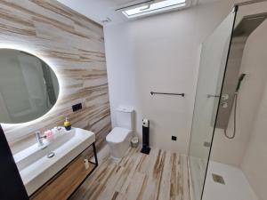 a bathroom with a sink and a mirror and a toilet at VILLA CALA LLARGA BEACH in Roses +36 photos