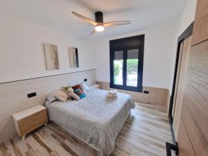 a bedroom with a bed and a ceiling fan at VILLA CALA LLARGA BEACH in Roses