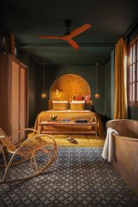 a bedroom with a bed and a ceiling fan at The Mellah Hotel in Marrakesh
