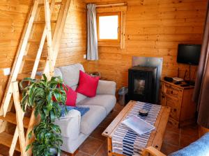 a living room with a couch and a fireplace at Finca Mariposa Mariposaholidays in Nerja