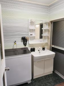 a white bathroom with a sink and a mirror at Villa9 in Onjuku +10 photos