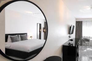a bedroom with a bed and a large mirror at VISIONAPARTMENTS Freyastrasse - self check-in in Zurich