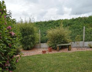 a park bench sitting in the middle of a yard at Les Jeux du Moulin in Nouans-les-Fontaines