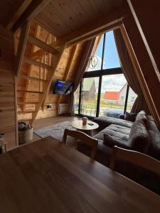 a living room with a couch and a table at TriView in Žabljak