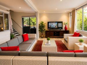 a living room with a couch and a tv at The Glen Getaway in Lake Brenton +42 photos