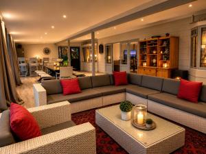 a living room with a large couch and red pillows at The Glen Getaway in Lake Brenton