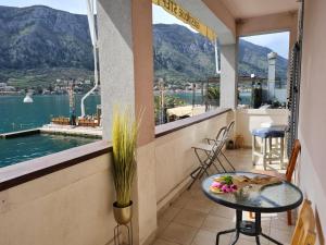 a balcony with a table and a view of the water at Step to Kotor bay Guesthouse in Kotor
