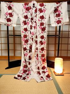 a dress on a table next to a candle at Villa near Kinkakuji Pets OK free Parking 金閣寺周辺 貸切町屋 ペットOK 無料駐車場 in Kinugasa