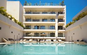 an external view of a building with a swimming pool at Enorme Epavli Urban Living in Hersonissos +39 photos