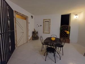 a dining room with a table and chairs and a door at A due passi dal mare in Ribera +14 photos
