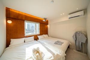 a bedroom with two beds with shoes on the bed at Monday Mansion Hotel in Seoul